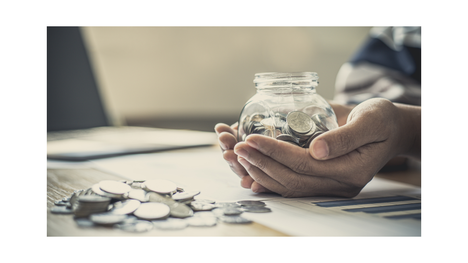 Image of hand holding a pot of coins